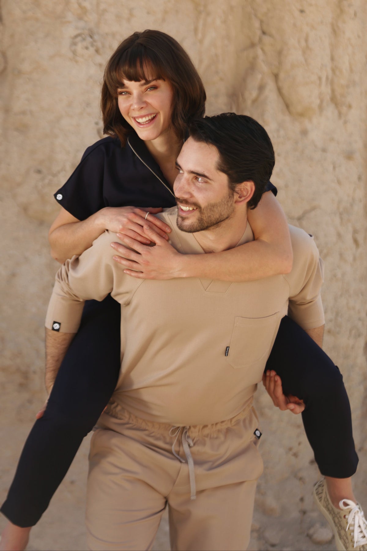 Man wearing Classic Natural Scrub Top showing the long sleeves and relaxed professional fit