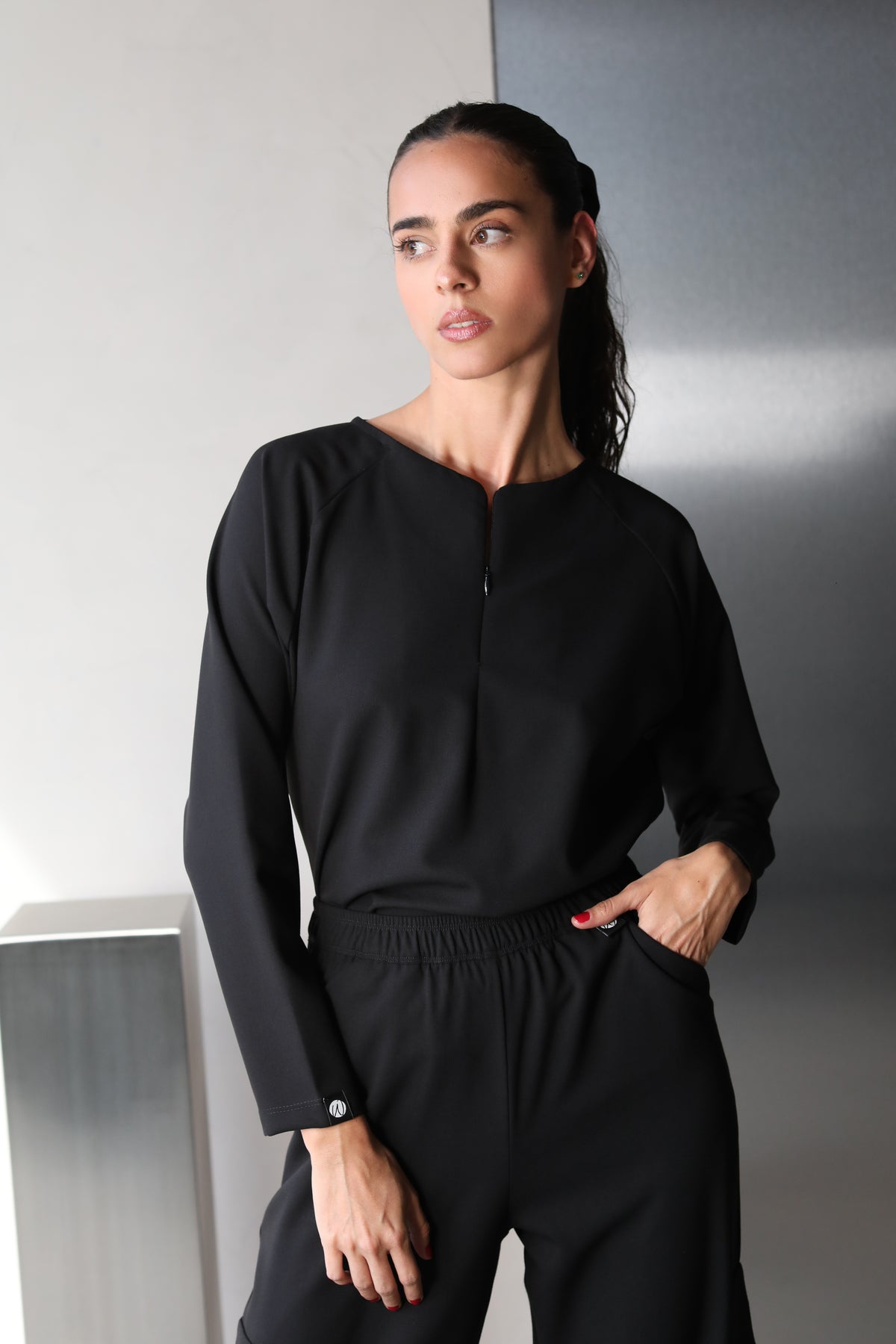 Woman wearing Fall Black Scrub Top by Work & Chill
