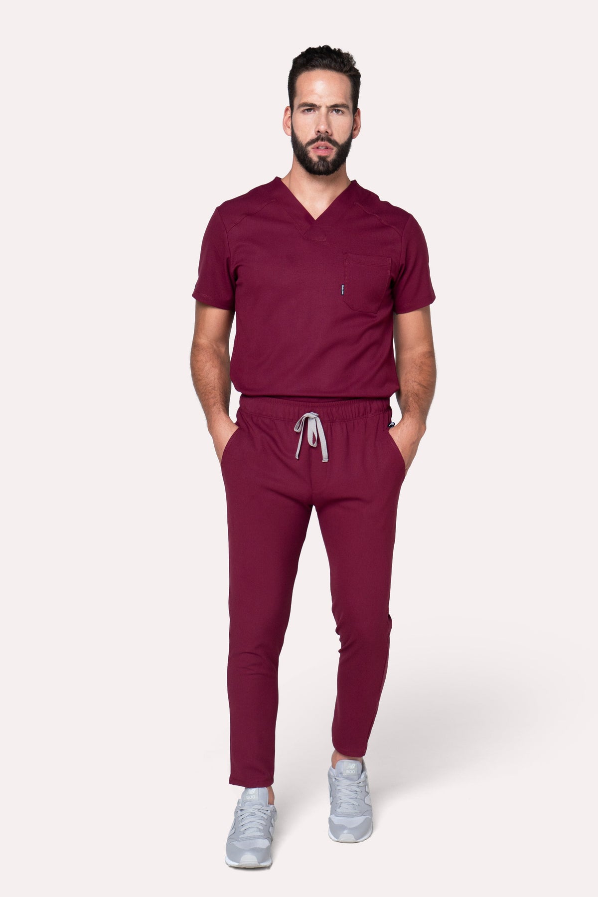 Man wearing Fresh Burgundy Scrub Pants showing the tapered jogger silhouette