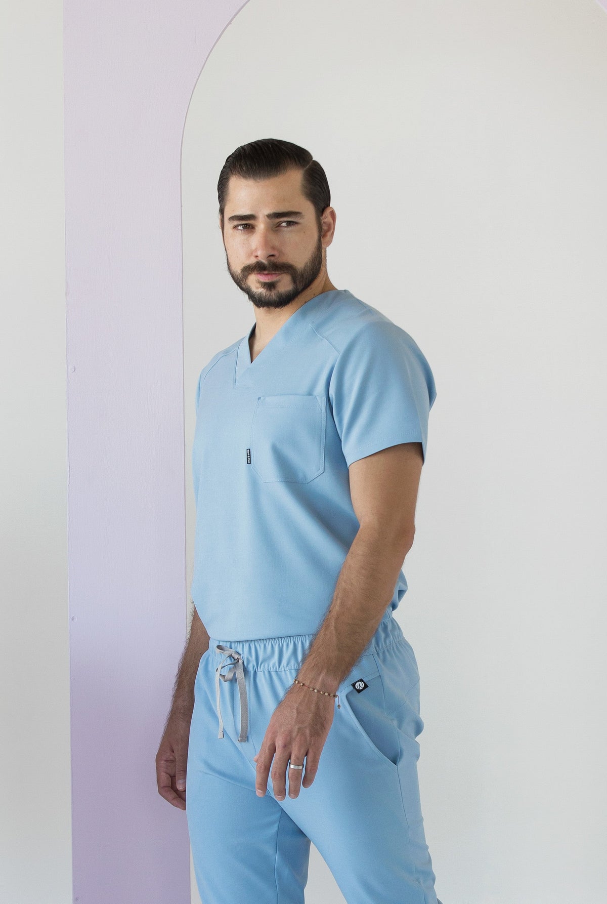 Side view of Fresh Dream Blue Scrub Top showing the relaxed fit and V-neckline