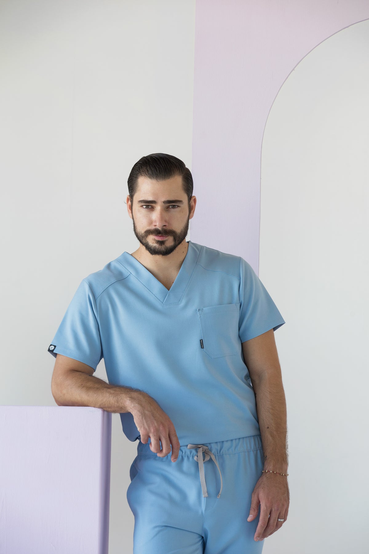 Man wearing Fresh Dream Blue Scrub Top showing the comfortable everyday fit