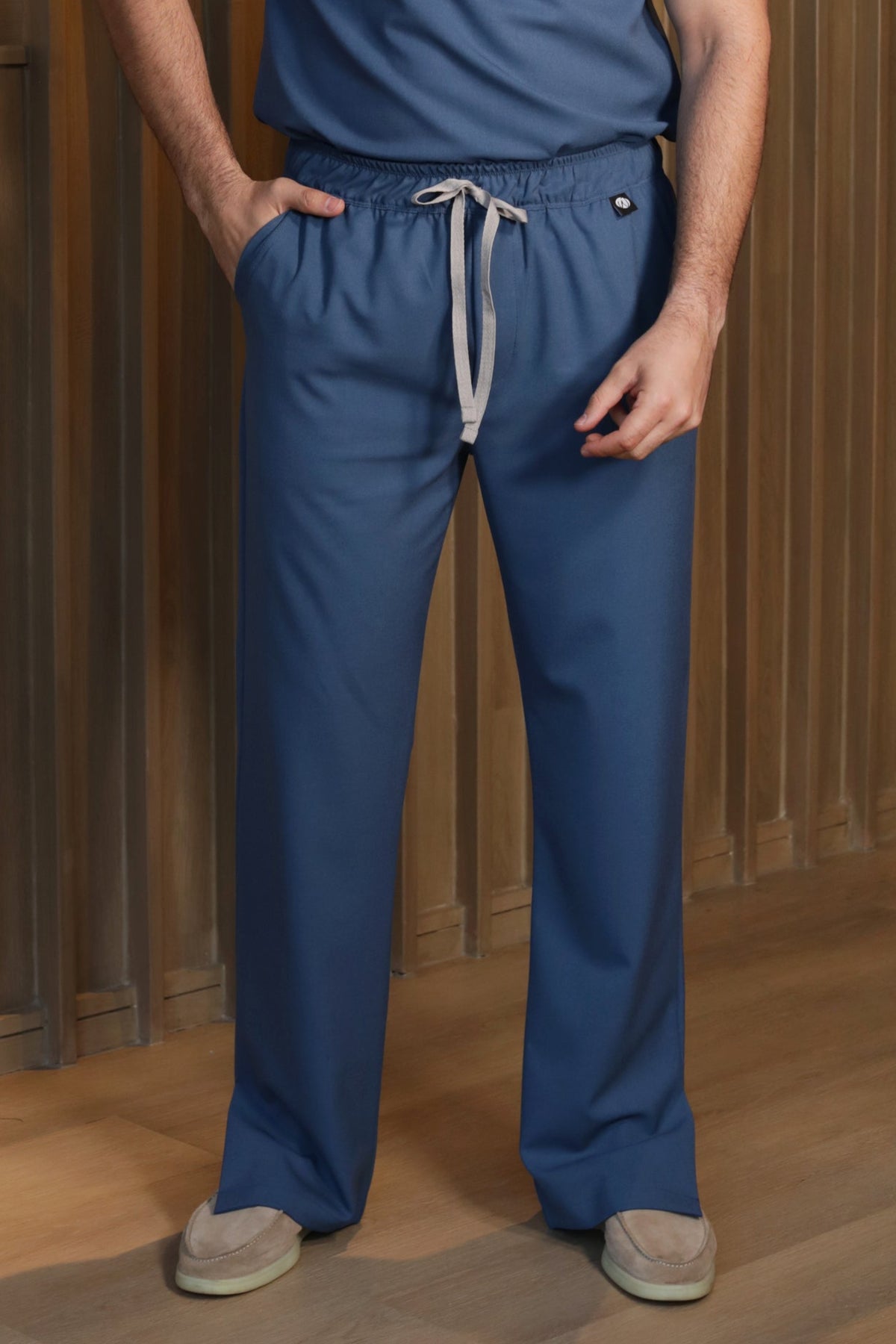 Man wearing Harry Indigo Scrub Pants by Work & Chill