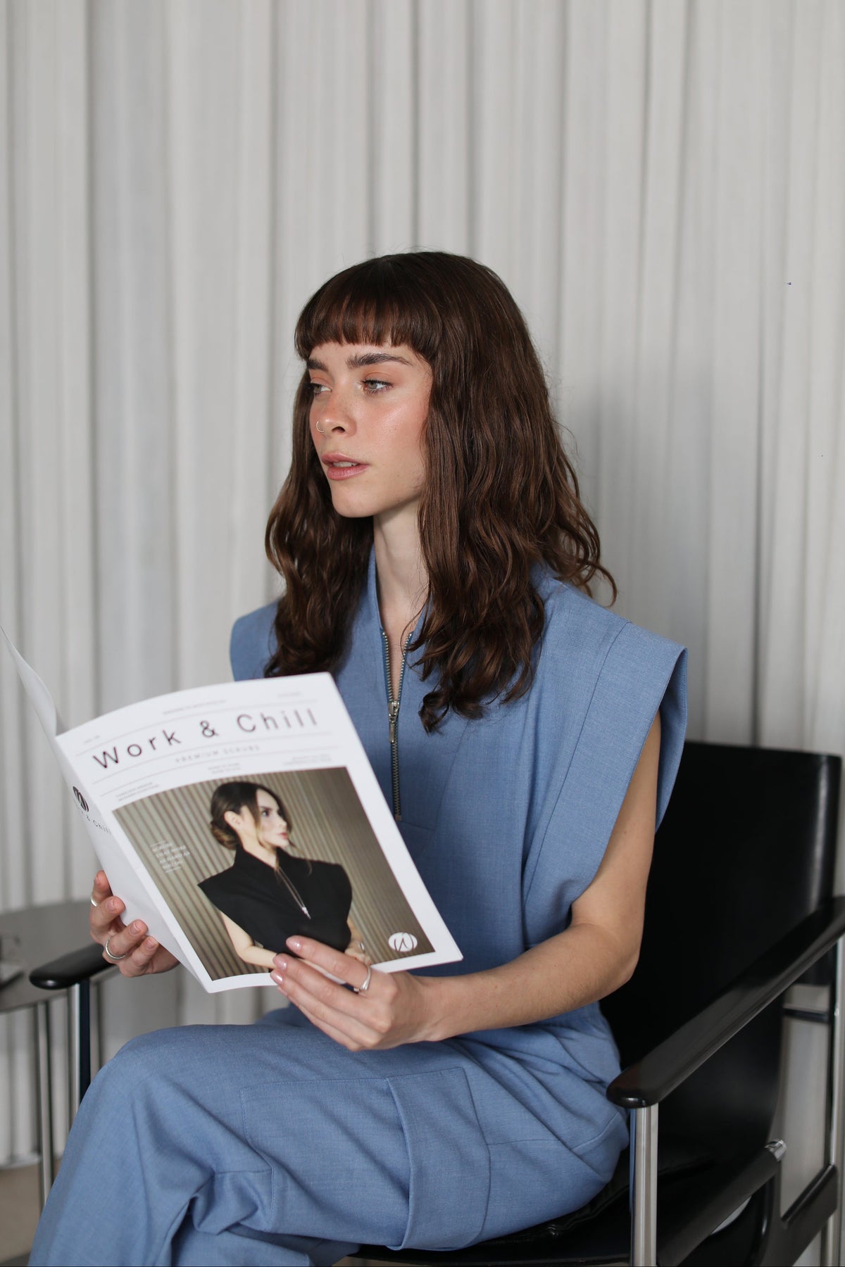 Model wearing Kate Chambray Scrub Top and matching scrub pants in an editorial setting