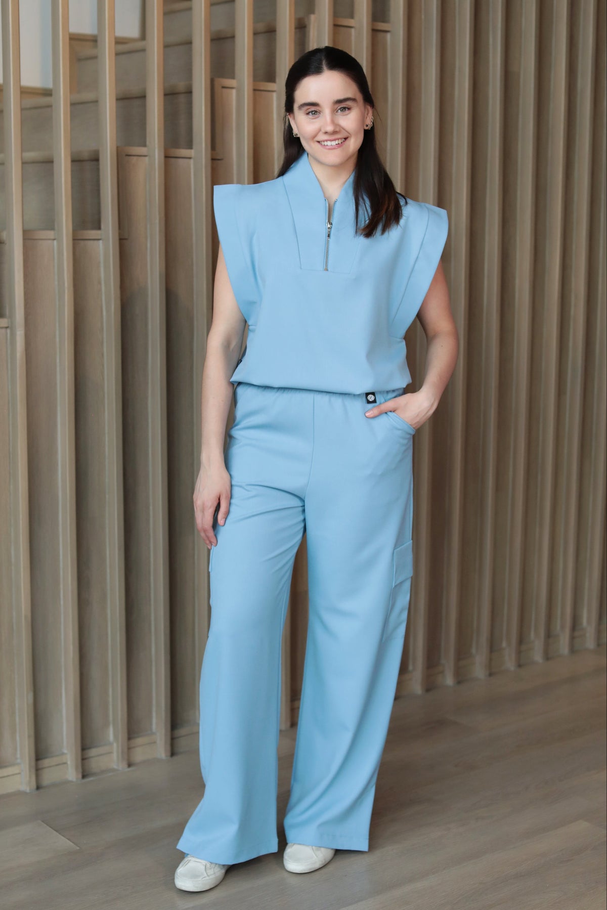Model wearing Kate Dream Blue Scrub Pants with the matching Kate Scrub Top