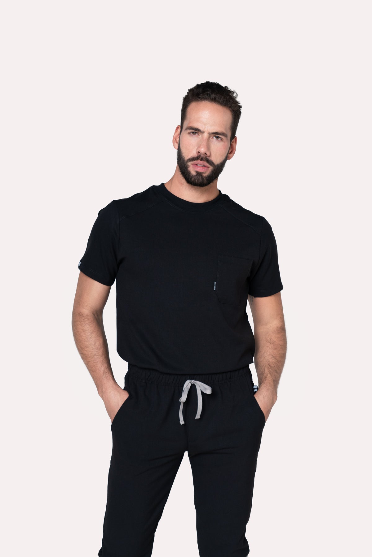 Man wearing Sport Black Scrub Top by Work & Chill