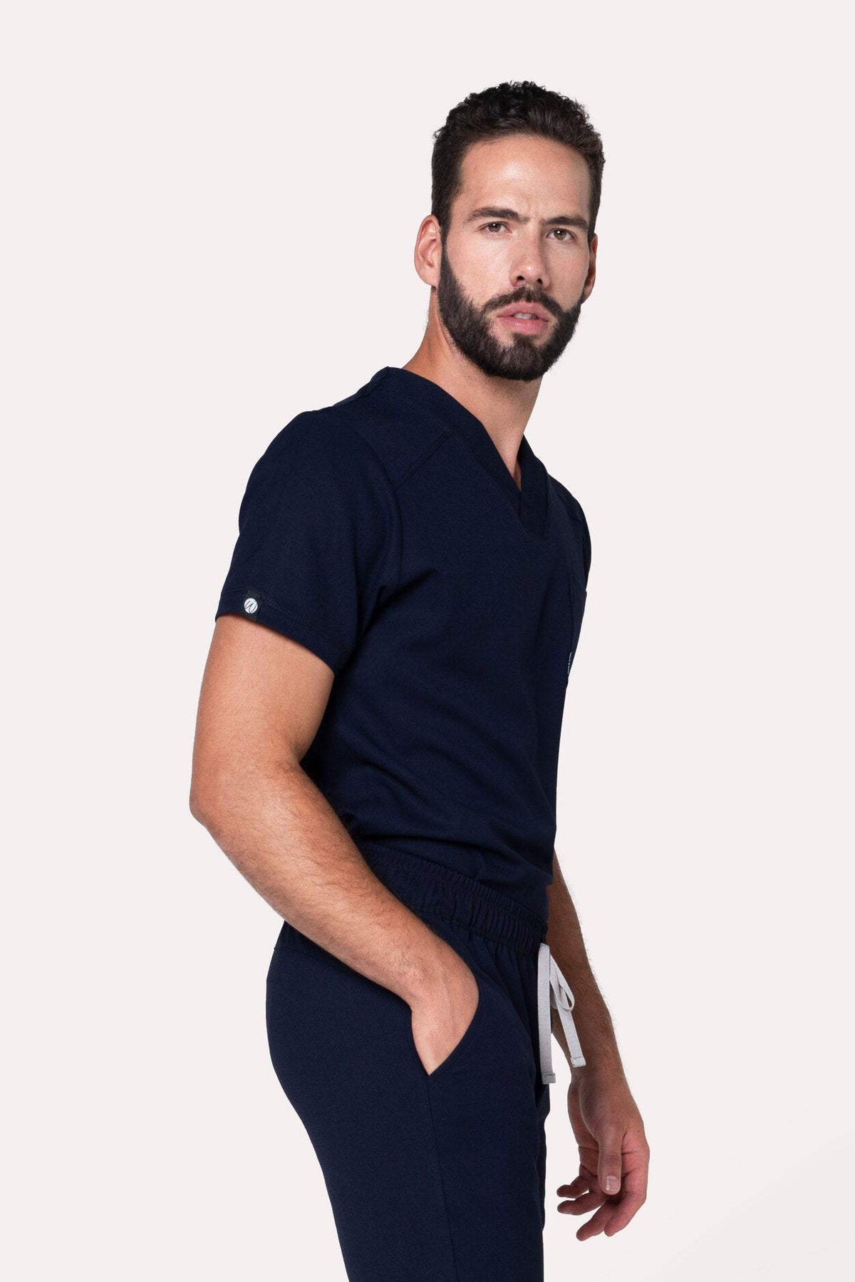 Side view of Fresh Navy Scrub Top showing the V-neckline and fit