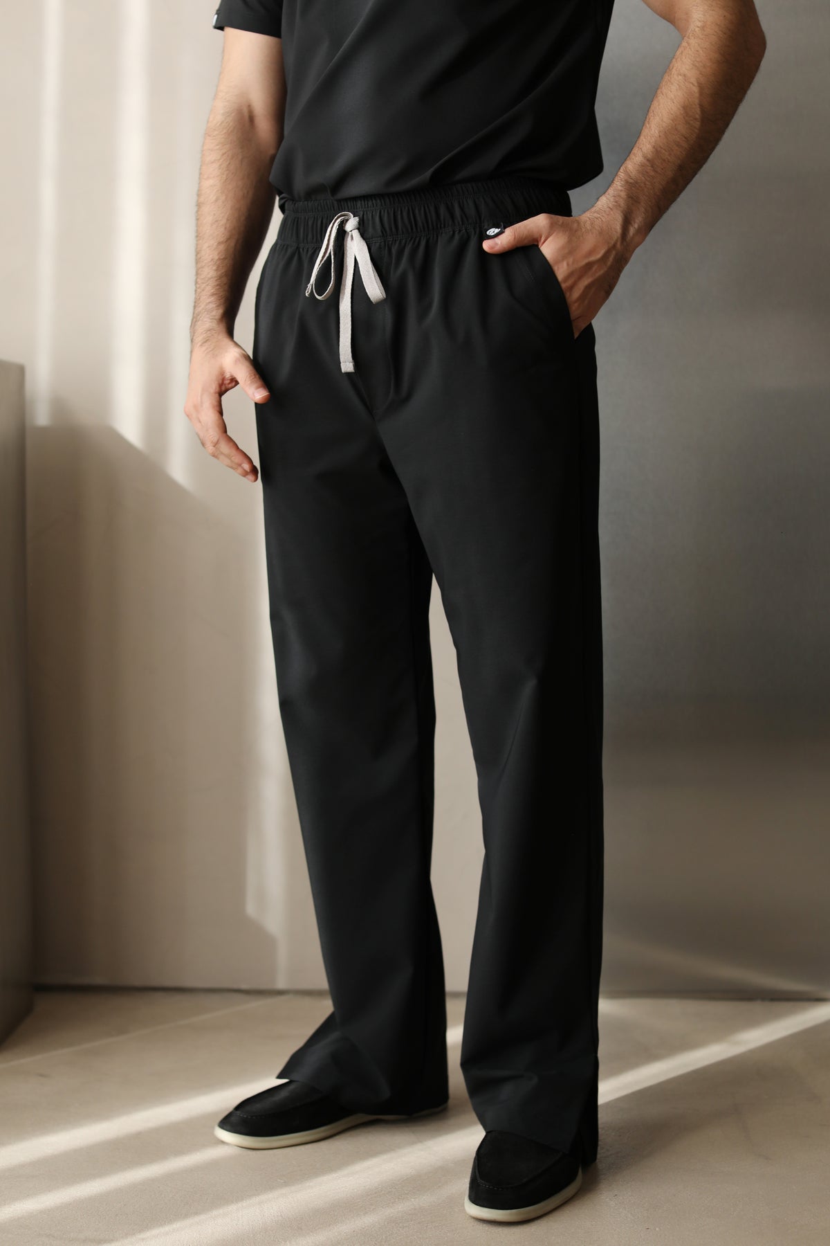 Front view of a man wearing Harry Black W&C Shield™ scrub pants, highlighting the straight-leg fit, drawstring waistband, and side pockets.