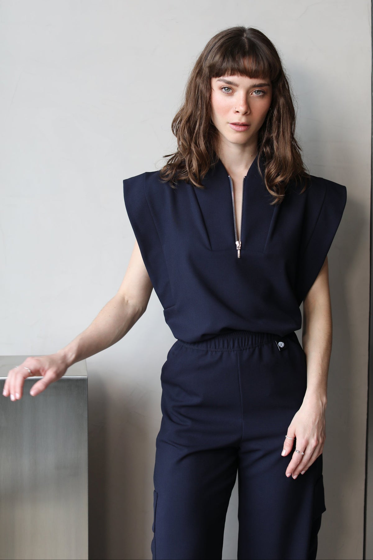 Woman wearing Kate Navy Scrub Top by Work & Chill
